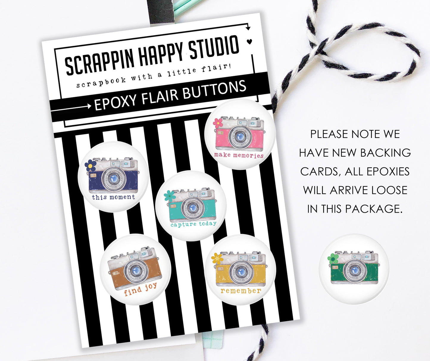 a package of epoxy flair buttons from Scrappin Happy Studio, with a note about the new backing cards.