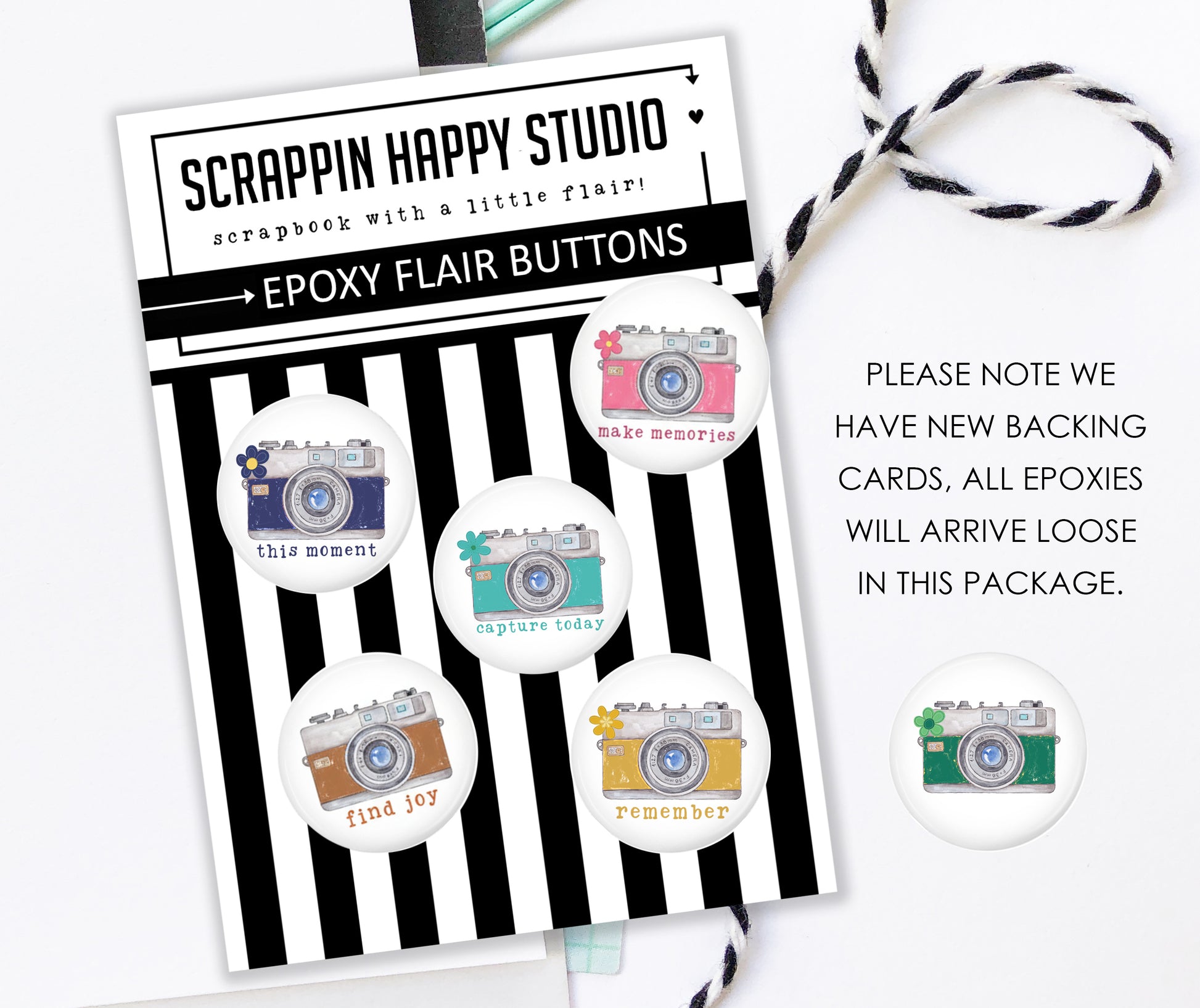 a package of epoxy flair buttons from Scrappin Happy Studio, with a note about the new backing cards.
